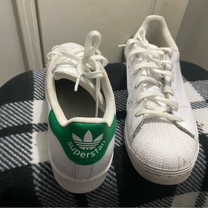 Green and white shell toe Adidas